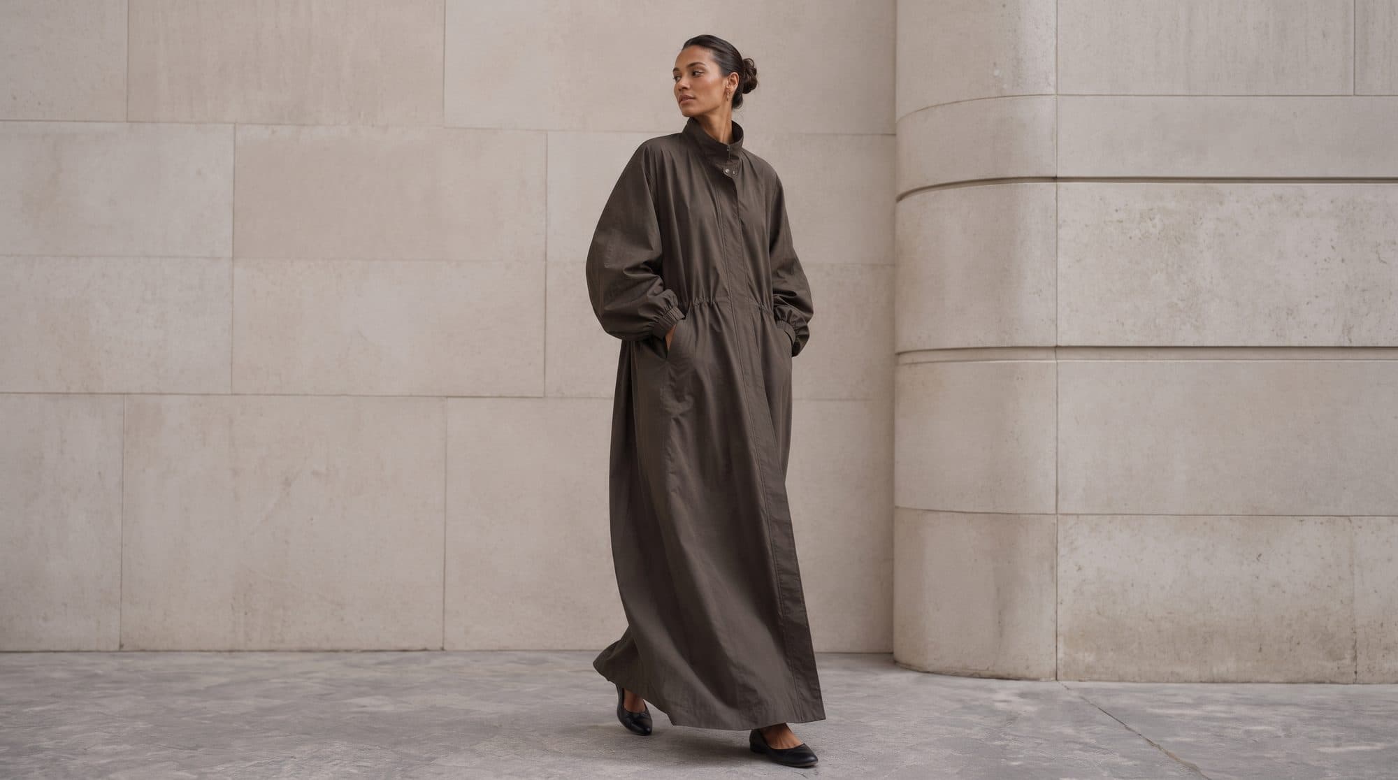 Taupe crêpe against poured limestone — the colour the city turns at four o'clock.