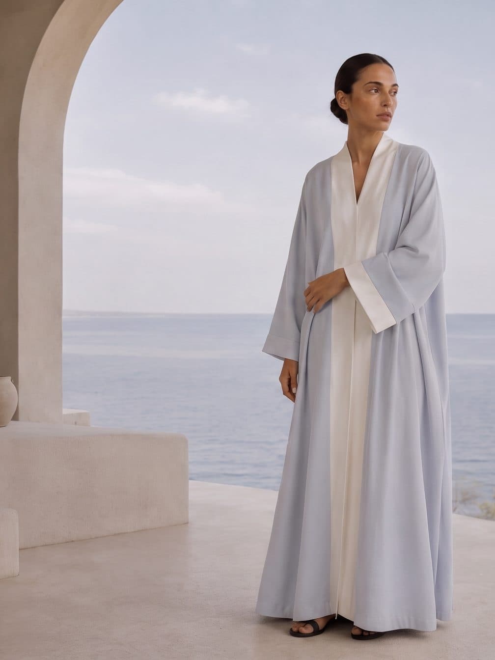 A pale bicolour abaya on a terrace above the sea